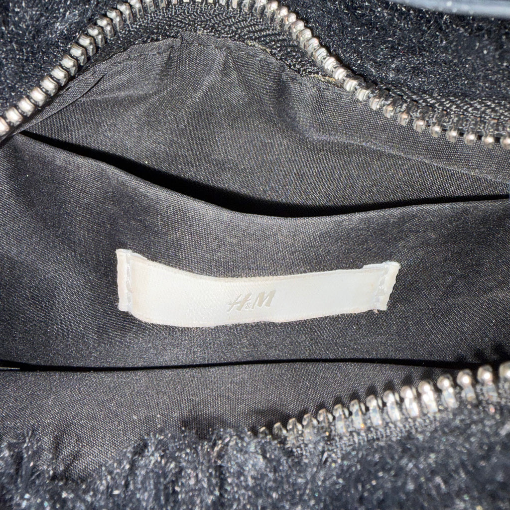 black fur bag with faux leather straps